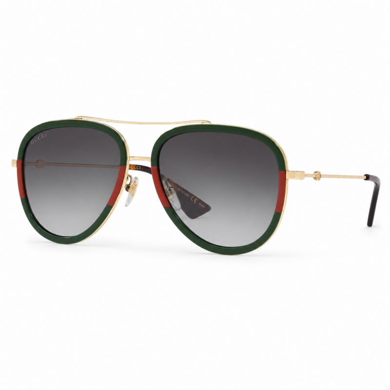 Lentes de sol Gucci estilo aviador con detalles verde y rojo, estructura dorada y cristales degradados en vista principal sobre fondo blanco.